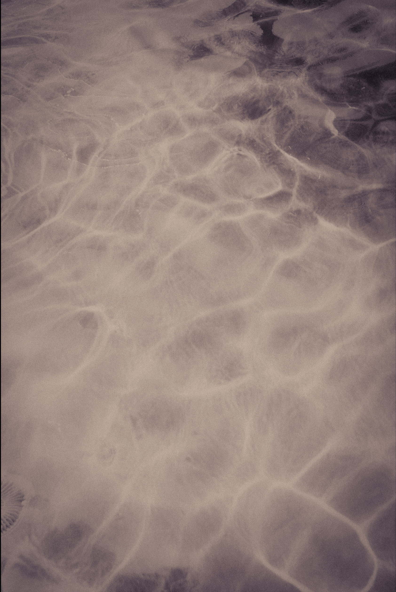 Close view of pale, flowing water patterns.